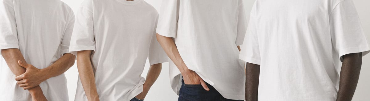 Plain white cotton t-shirts worn side by side, showing the crew neck and the full front print area