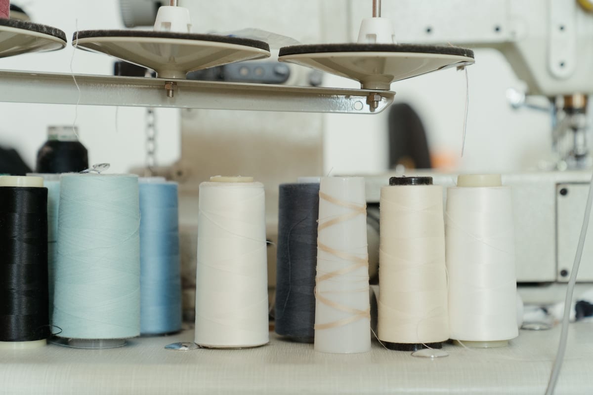 Cones of polyester embroidery thread loaded on an industrial embroidery machine